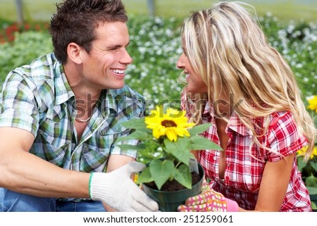 Gardening people. Couple working in garden with flowers.
