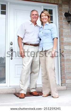 Senior couple at new home. Retirement security concept.