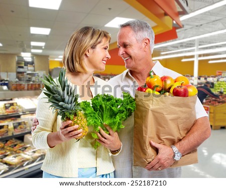 Senior shopping couple with grocery items . Healthy diet.