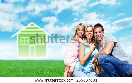 Happy family near new house. Real estate background.