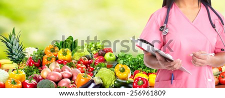 Medical doctor woman over Diet and health care background.