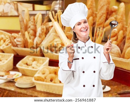Mature professional chef woman in modern restaurant.