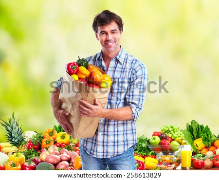 People with Vegetables over green background. Healthy diet.