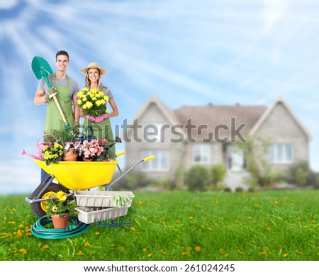 Gardening people. Couple with flowers in the garden.