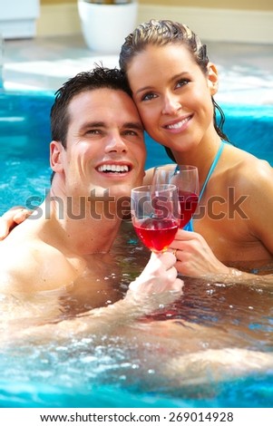 Young couple relaxing in hot tub. Summer vacation.