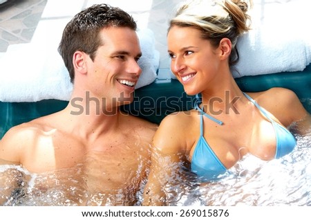 Young couple relaxing in hot tub. Summer vacation.