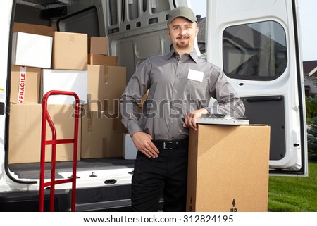 Young postman with parcel near delivery truck. Shipping service.