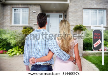 Young loving couple looking at new home. Mortgage.