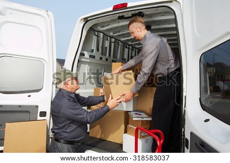 Delivery men with parcels near cargo truck. Post service.