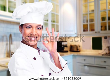 Smiling chef woman at the modern kitchen