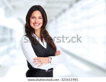 Portrait of happy young business woman over office background