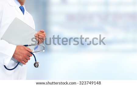 Hands of medical doctor with clipboard. Health care background.