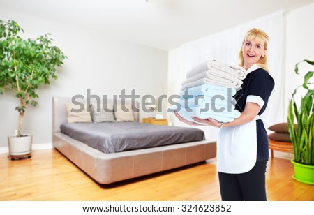 Maid woman with towels. House cleaning service concept.
