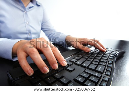 Hands of business woman typing on computer keyboard. Isolated white.