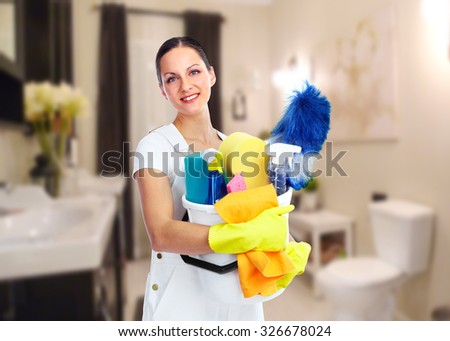 Young smiling maid. House cleaning service concept.