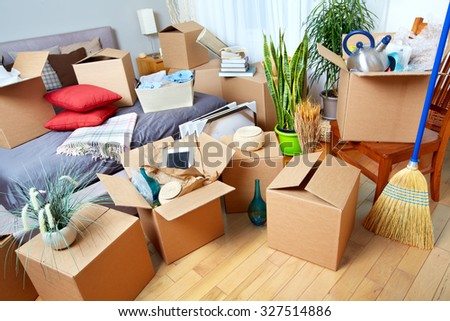 Moving boxes in new house. Real estate concept.