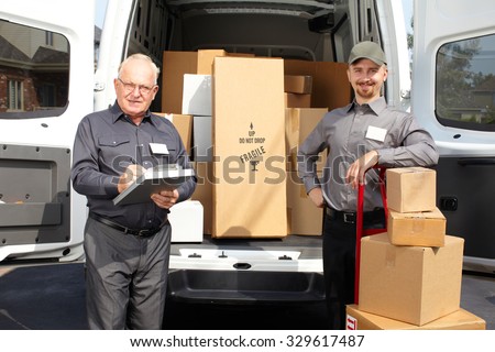 Group of delivery men with parcels near shipping truck. Parcel service.