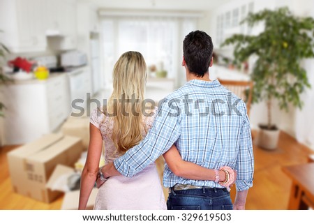 Young couple in a new house. Real estate and moving background.