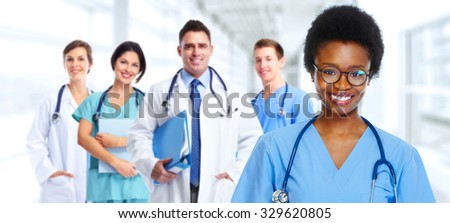 Group of medical doctors over hospital background. Health care.