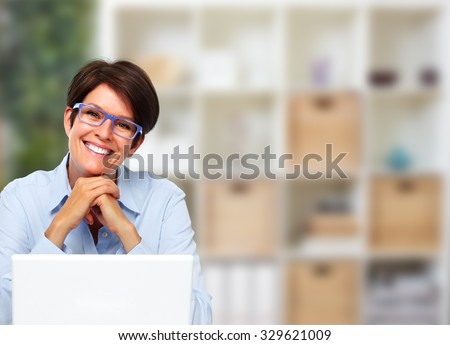 Beautiful business lady with laptop computer in office.