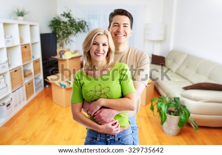 Happy couple at home. Real estate background.