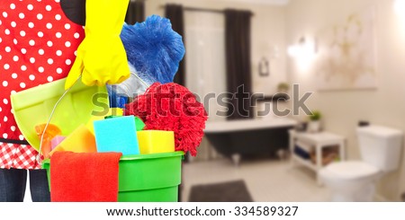 Maid hands with cleaning tools. House cleaning service concept.