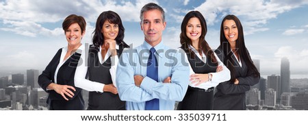Group of smiling business people over urban background