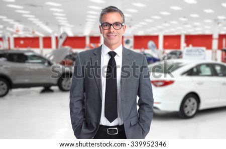 Car dealer man. Auto dealership and rental concept background.
