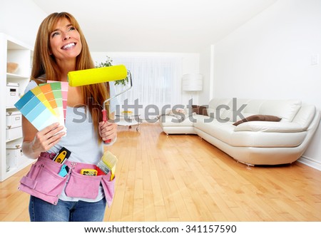 Woman with a painting roller. Home and house renovation.