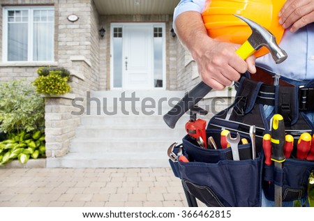 Hands of Handyman with a tool belt.