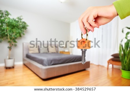 Hand with house key.