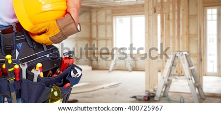 Builder handyman with construction tools.