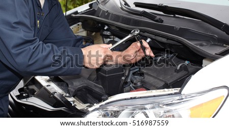 Car mechanic with wrench.
