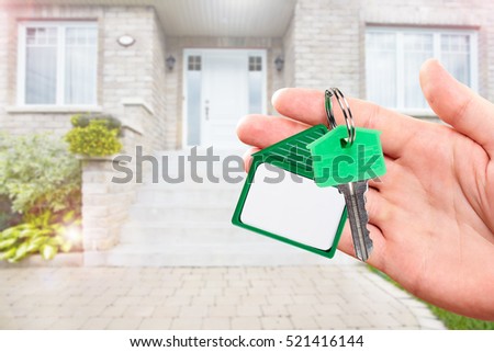 Hand with house key.
