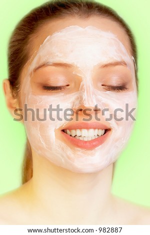Sweet skincare. Attractive girl applying face pack.