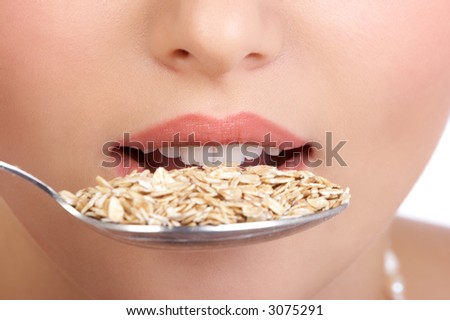 Pretty  woman holding a spoon with muesli