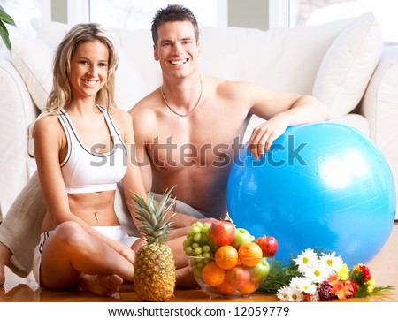 Young love couple with fruits in the comfortable apartment