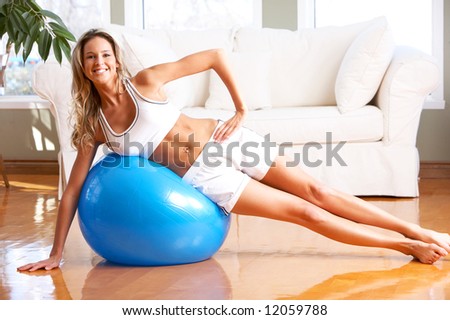 Young woman working out  in the sunny room