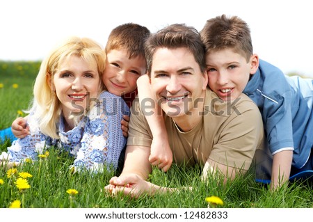 Happy family. Father, mother and sons in the park