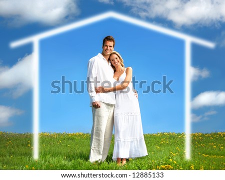 Young love couple smiling under blue sky.  Real estate concept