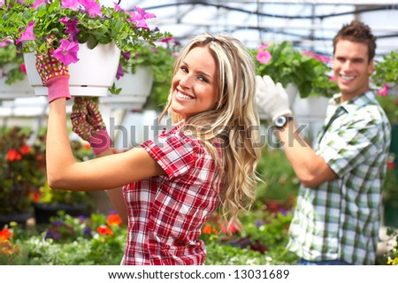 Florists on Young Smiling People Florists Working In The Garden Stock Photo