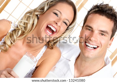 Young love couple  drinking milk. Over white background