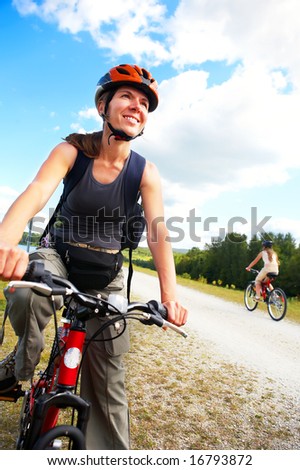 Young smiling  woman cycling in the park