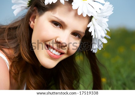 Beautiful woman with  flower diadem under blue sky