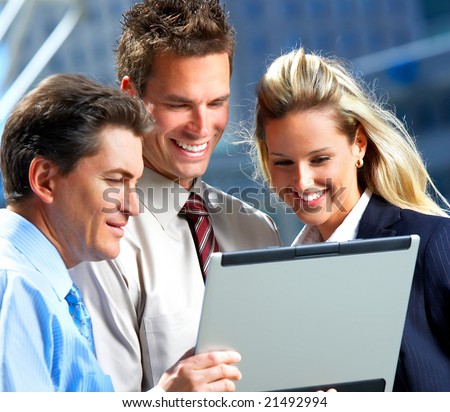 Smiling business people working with laptop