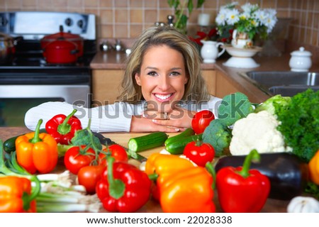 Young smiling woman  cooking in the kitchen
