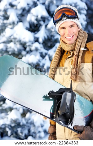 Young  happy smiling man with snowboard. Winter sport