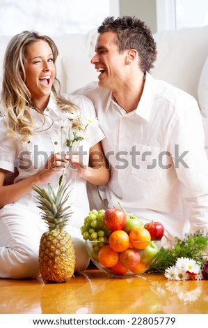 Young love couple with fruits in the comfortable apartment