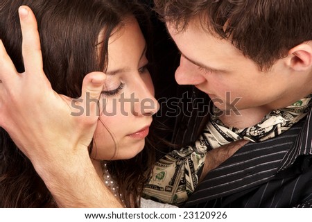 Young couple in love.  Over dark background