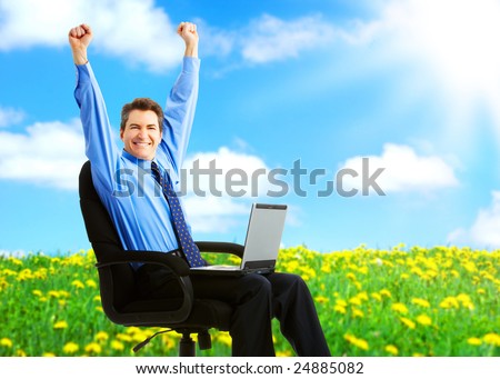 Successful happy businessman with laptop under blue sky.